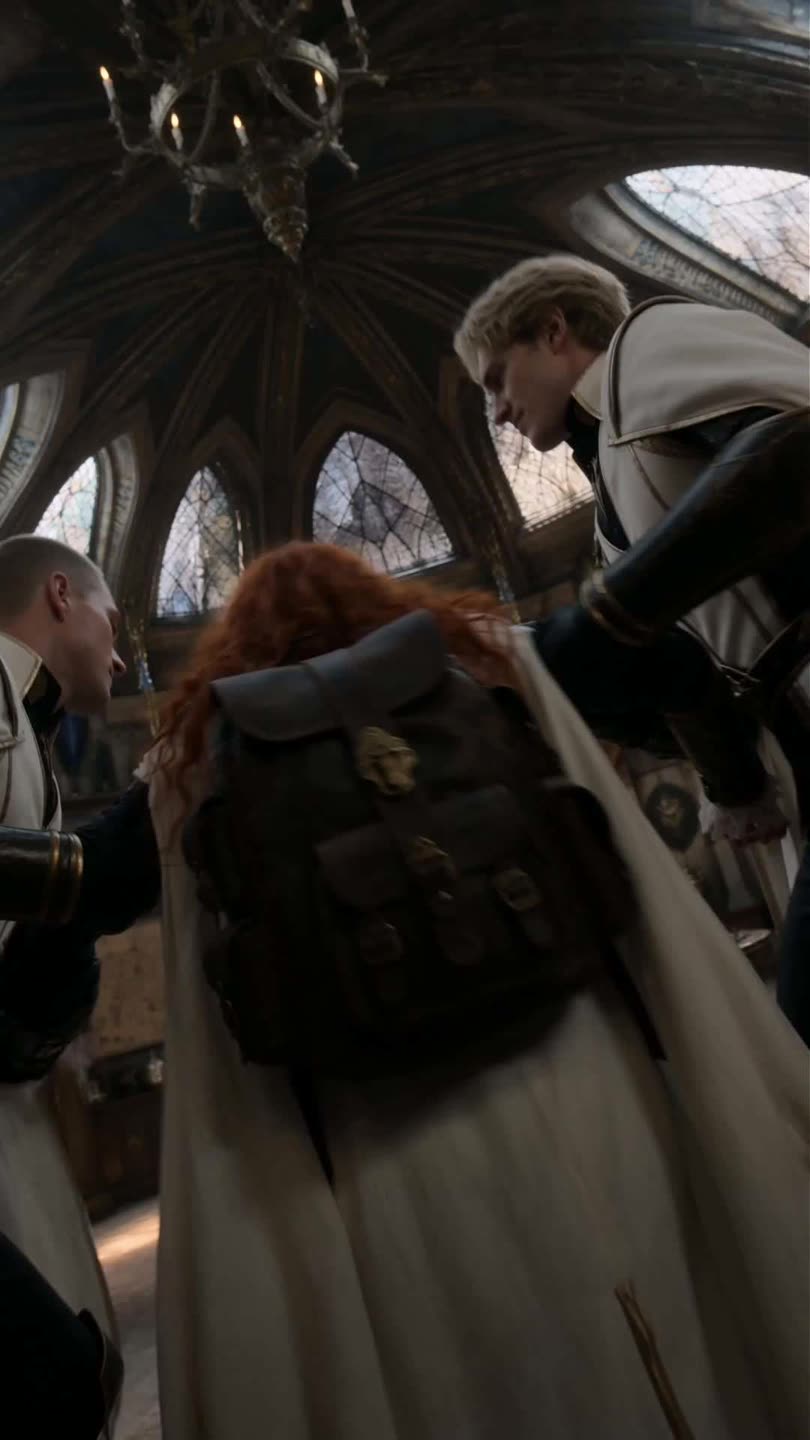 Still from episode 4: the red-haired lead surrounded by white-caped riders in a vaulted hall